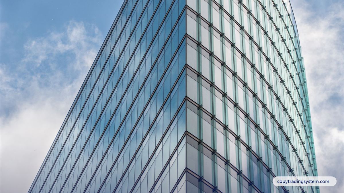 Choosing a forex broker: a modern glass office building against a blue sky